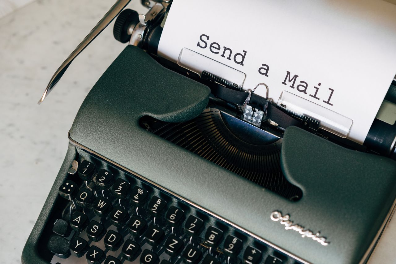 Close-up of a vintage typewriter typing 'Send a Mail' on paper, emphasizing nostalgic communication.